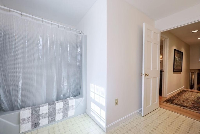 full bath featuring baseboards, a shower with shower curtain, and tile patterned floors