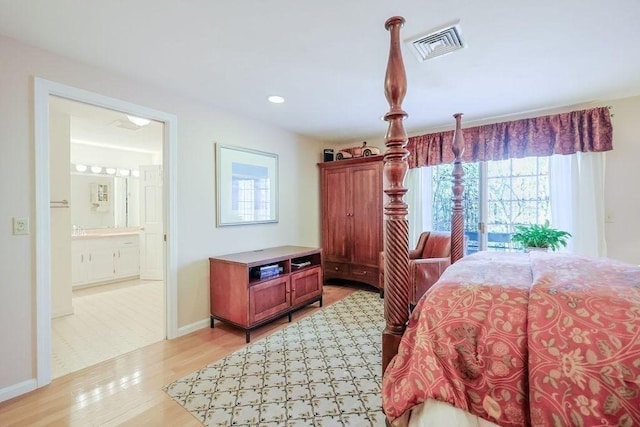 bedroom featuring ensuite bathroom, light wood-style flooring, recessed lighting, visible vents, and baseboards