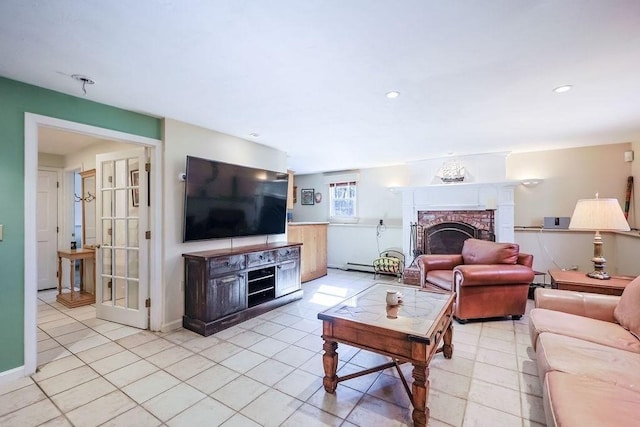 living room featuring baseboards, a fireplace, light tile patterned flooring, and recessed lighting