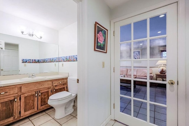 bathroom featuring toilet, vanity, and tile patterned floors