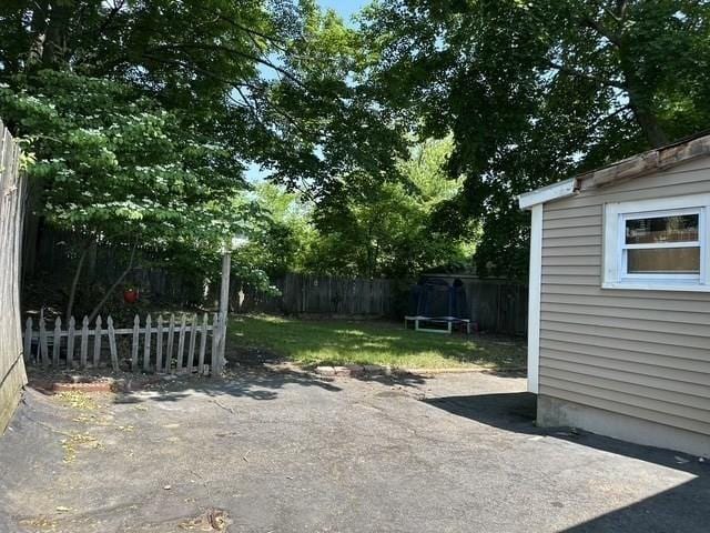 99 Allston St, Lawrence, MA 01841 - fenced backyard with a patio area