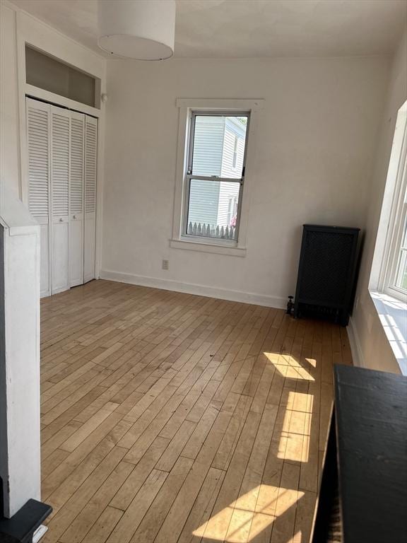 99 Allston St, Lawrence, MA 01841 - unfurnished bedroom featuring wood finished floors, a closet, and baseboards