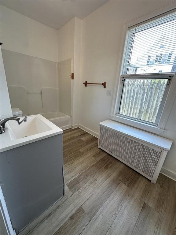 99 Allston St, Lawrence, MA 01841 - full bathroom featuring radiator heating unit, wood finished floors, baseboards, and vanity