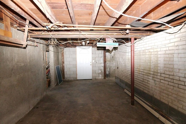 unfinished basement with a baseboard radiator