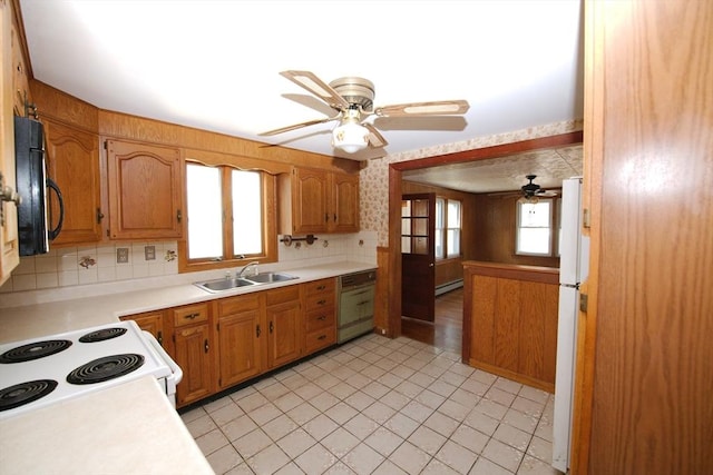 kitchen with a sink, light countertops, a ceiling fan, white appliances, and backsplash