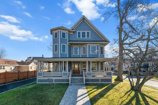 victorian home with covered porch and a front yard