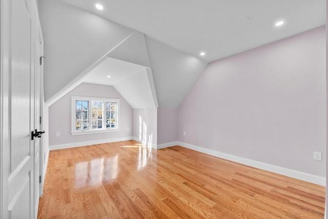 bonus room featuring light hardwood / wood-style floors and vaulted ceiling