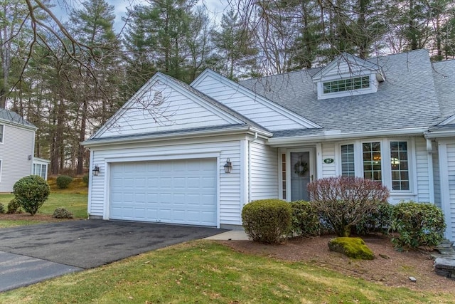 view of front of home featuring a garage and a front lawn