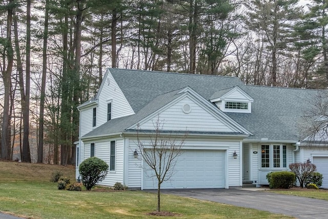 view of front of house with a front yard and a garage