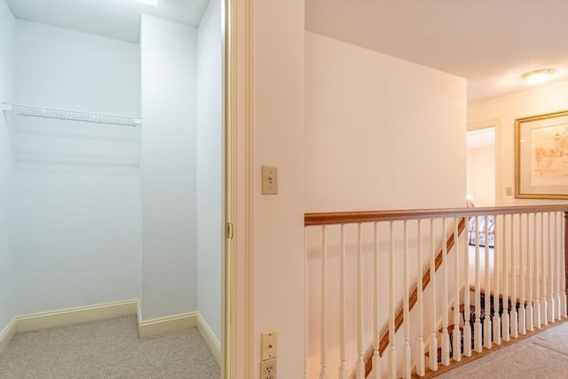 hall featuring carpet flooring