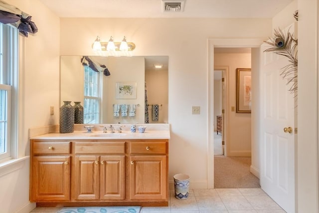 bathroom featuring tile patterned flooring and vanity