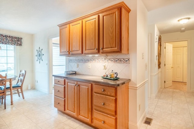 kitchen with backsplash and light tile patterned floors