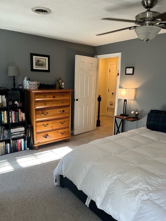 bedroom featuring ceiling fan and light carpet