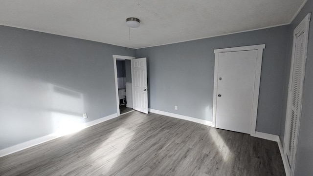 unfurnished bedroom featuring dark wood-type flooring