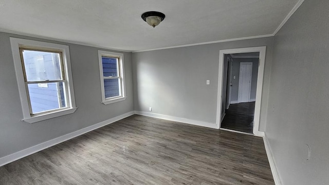 spare room with dark hardwood / wood-style flooring and ornamental molding