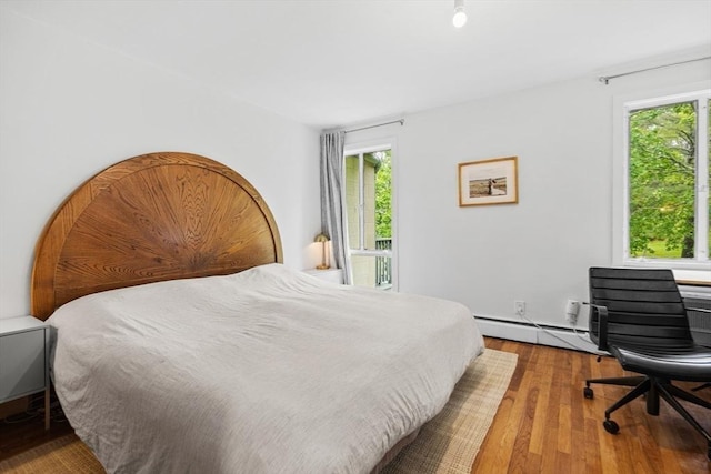 301 Neponset St Unit 12A, Norwood, MA 02062 - bedroom with multiple windows, wood finished floors, and a baseboard radiator