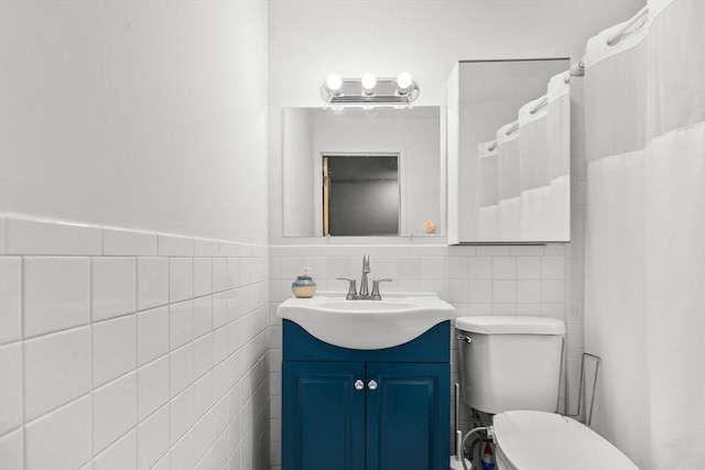 301 Neponset St Unit 12A, Norwood, MA 02062 - full bathroom with tile walls, vanity, toilet, a shower with shower curtain, and a wainscoted wall