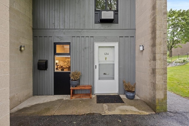 301 Neponset St Unit 12A, Norwood, MA 02062 - view of exterior entry featuring board and batten siding and cooling unit