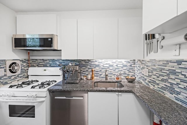301 Neponset St Unit 12A, Norwood, MA 02062 - kitchen featuring appliances with stainless steel finishes, white cabinetry, and tasteful backsplash