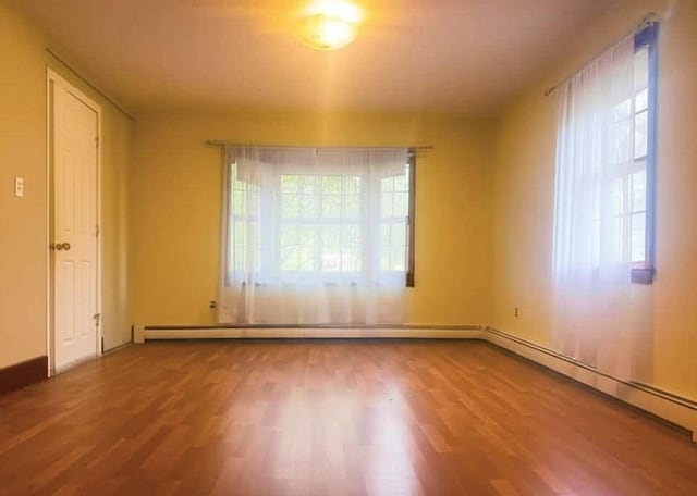59 Katherine St, Weymouth, MA 02191 - spare room featuring wood finished floors, a baseboard heating unit, and baseboards