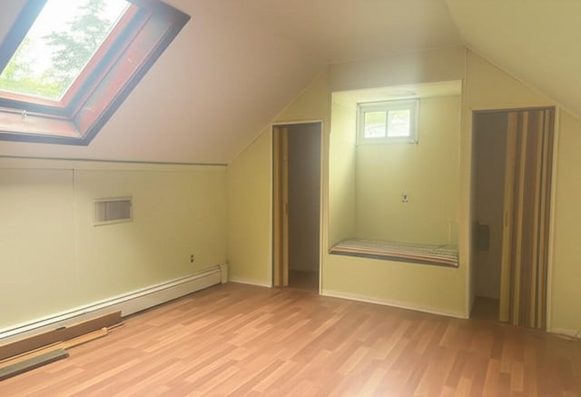 59 Katherine St, Weymouth, MA 02191 - bonus room featuring baseboard heating, light wood-style floors, lofted ceiling, and a skylight