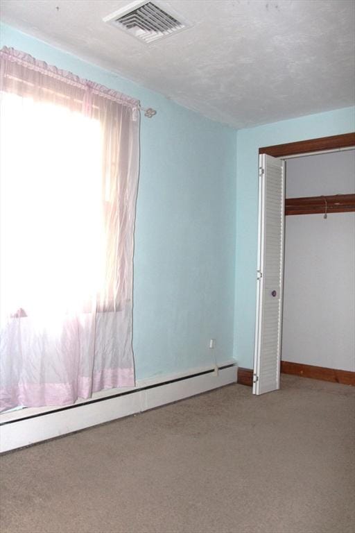 59 Katherine St, Weymouth, MA 02191 - unfurnished bedroom with light carpet, baseboard heating, and a closet