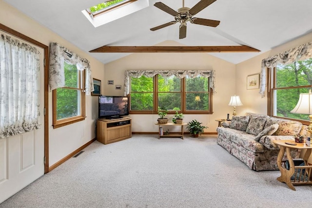 living room featuring carpet flooring, healthy amount of natural light, baseboards, and a skylight