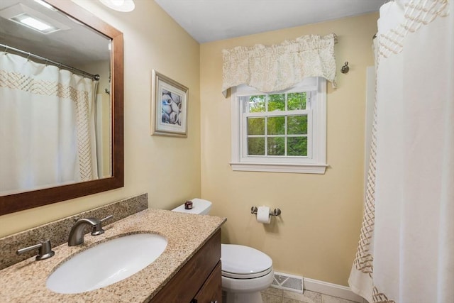 bathroom with toilet, vanity, baseboards, and tile patterned flooring