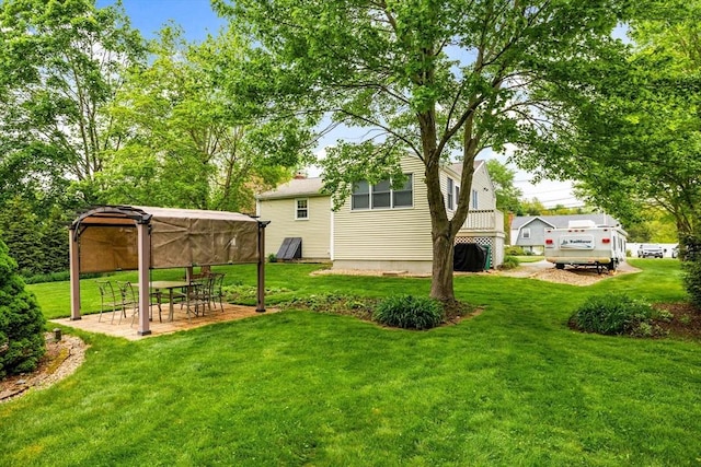 view of green lawn featuring a gazebo and a patio