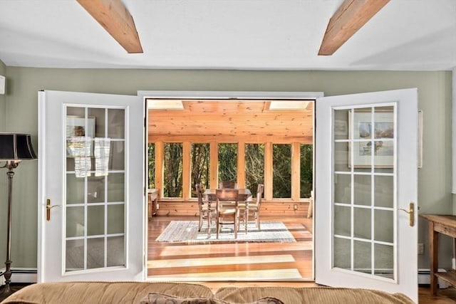 doorway featuring a baseboard radiator and beam ceiling