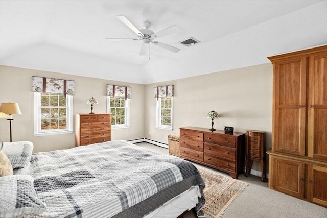 bedroom with ceiling fan, lofted ceiling, a tray ceiling, and light carpet