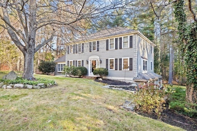 colonial-style house with a front lawn