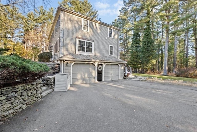 view of side of home featuring a garage