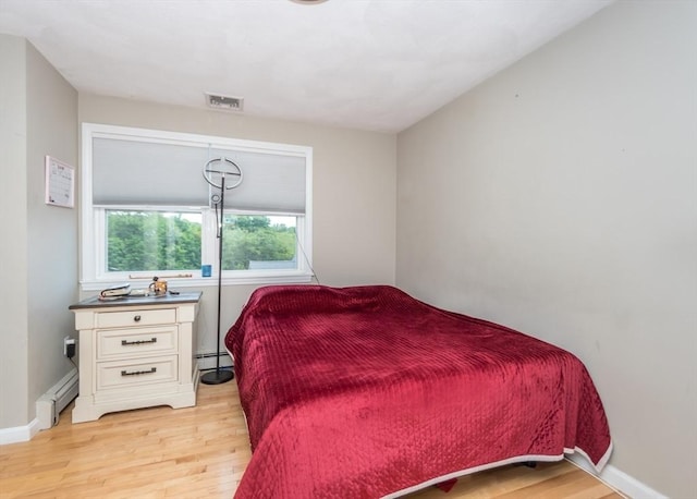 140 College Farm Rd, Waltham, MA 02451 - bedroom with baseboard heating, light wood-style floors, and baseboards
