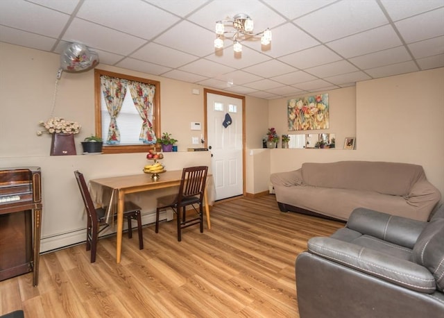 140 College Farm Rd, Waltham, MA 02451 - living room featuring light wood finished floors, a paneled ceiling, and a baseboard radiator