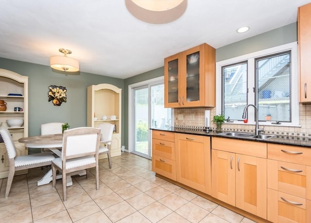140 College Farm Rd, Waltham, MA 02451 - kitchen with a sink, tasteful backsplash, dark countertops, glass insert cabinets, and light tile patterned flooring