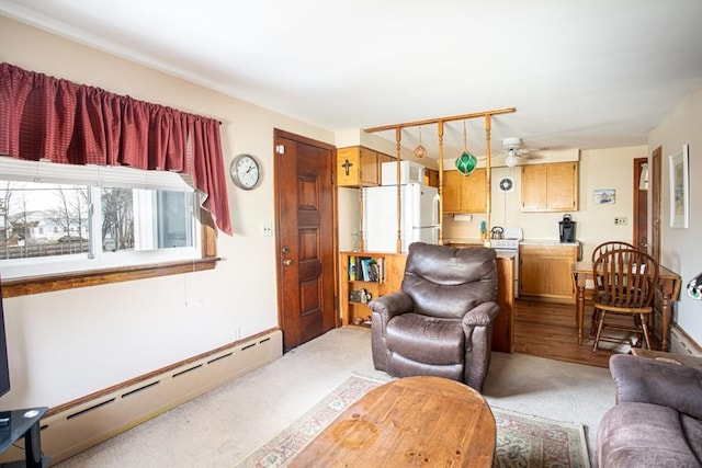 carpeted living room featuring a baseboard heating unit