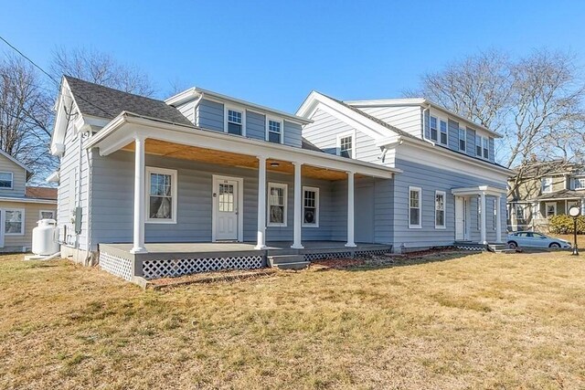view of front of house featuring covered porch and a front yard