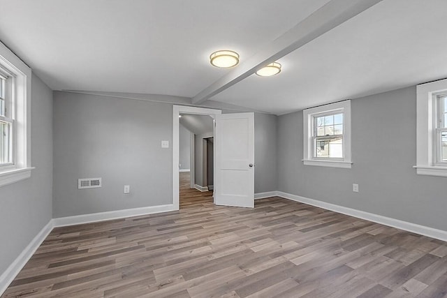 unfurnished bedroom with wood finished floors and baseboards