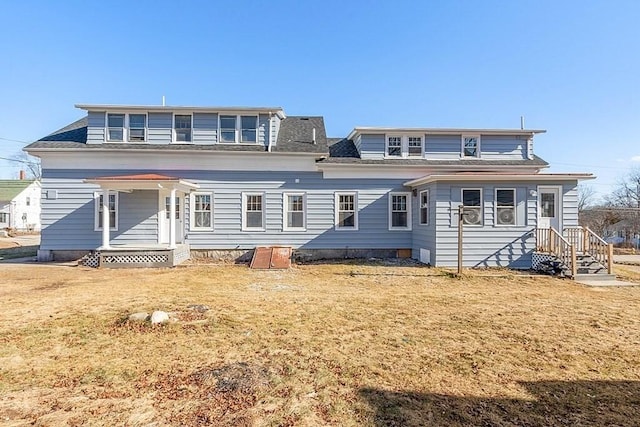 back of property featuring a lawn and a porch