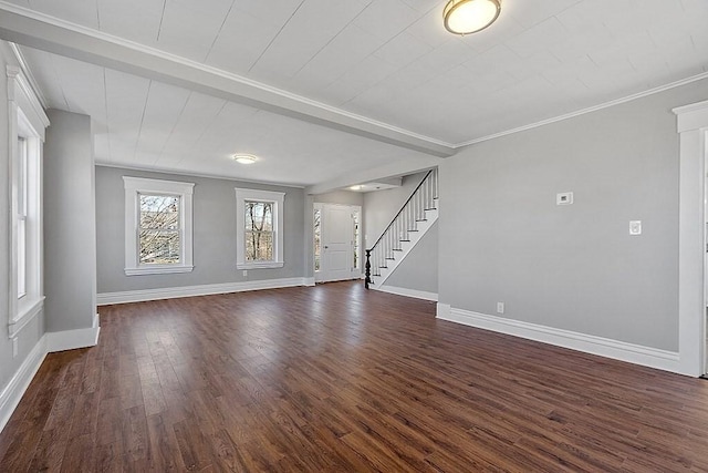 unfurnished living room with baseboards, stairway, dark wood-style floors, and crown molding