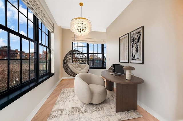 sitting room featuring light wood-type flooring and a chandelier