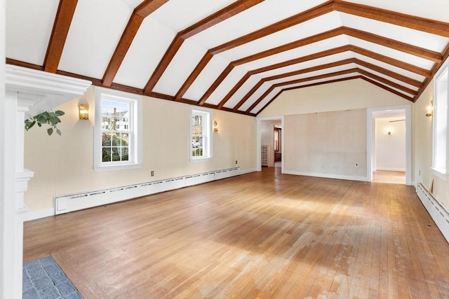 unfurnished living room with a baseboard heating unit, lofted ceiling, and wood-type flooring