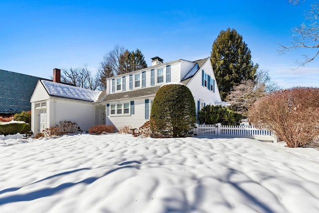 view of front of property with a chimney and fence