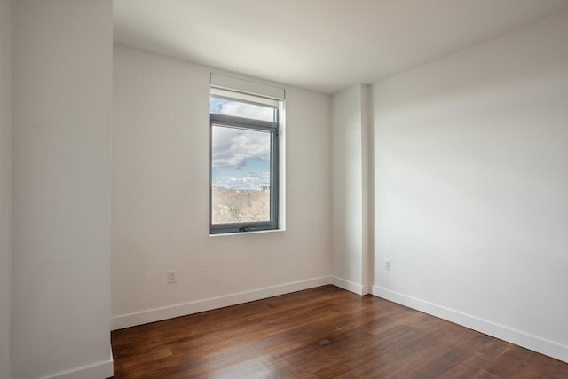 spare room featuring dark wood-type flooring