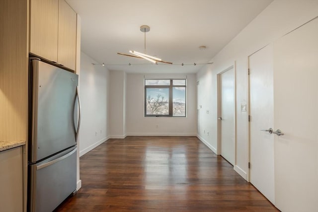 kitchen with dark hardwood / wood-style flooring and stainless steel fridge