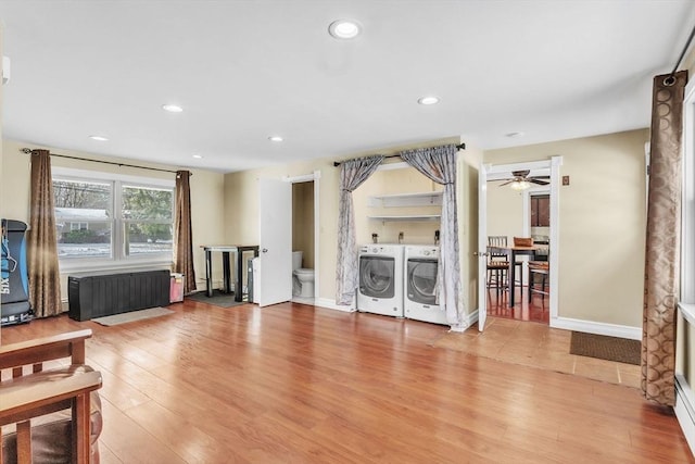 living room with wood-type flooring and washing machine and clothes dryer