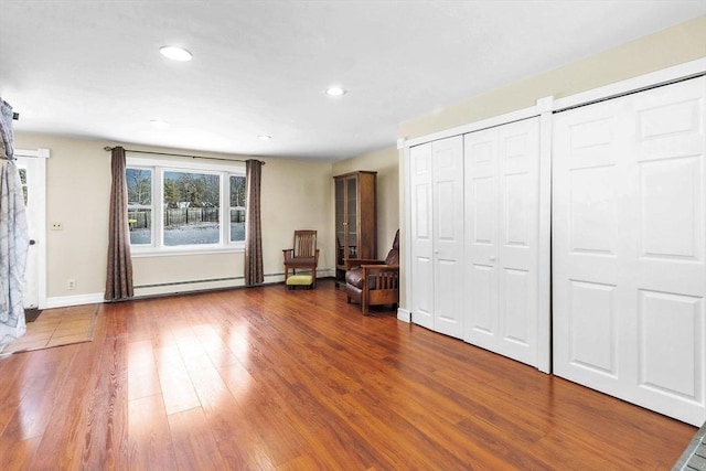 interior space featuring hardwood / wood-style flooring and a baseboard heating unit