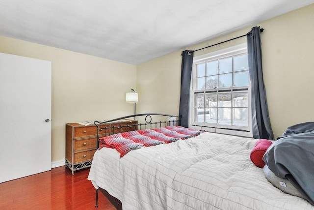 bedroom with dark wood-type flooring