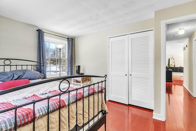 bedroom featuring hardwood / wood-style flooring and a closet